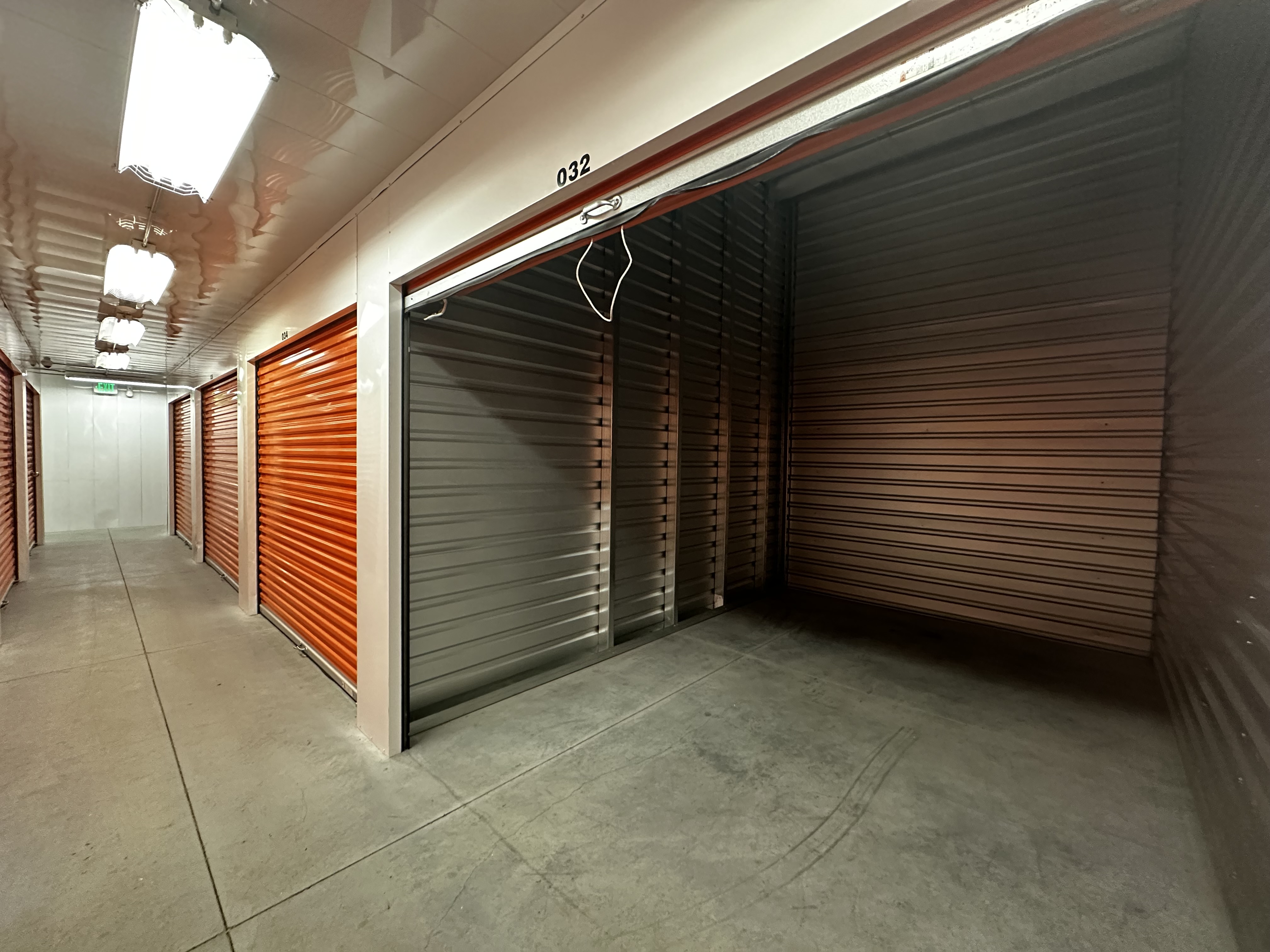 Indoor storage facility hallway with roll-up doors maintained by JC Property Maintenance in Utah