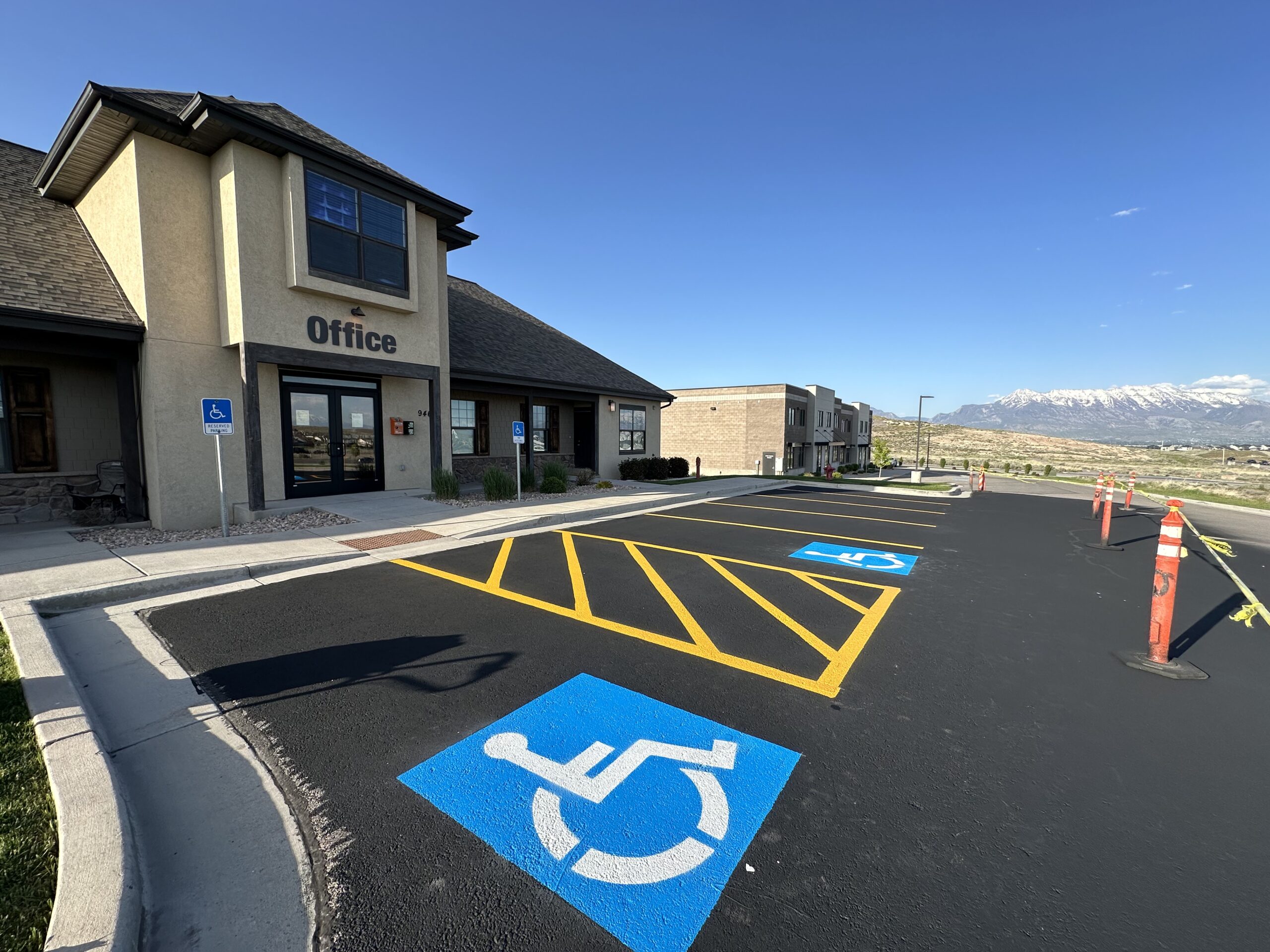 ADA compliant parking lot line striping with handicap symbols and Utah mountain backdrop by JCPM